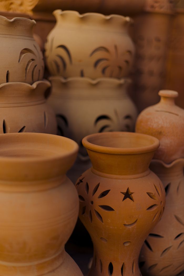 Beautiful traditional terracotta pottery displayed in a Dubai market, highlighting intricate designs.